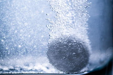effervescent tablet in a glass of water.