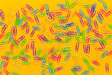 Paper color clip notebook on yellow background. Flat lay.