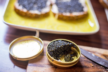 A Jar with Black Caviar on the Wooden Background, Preparing Sandwiches with Black Caviar