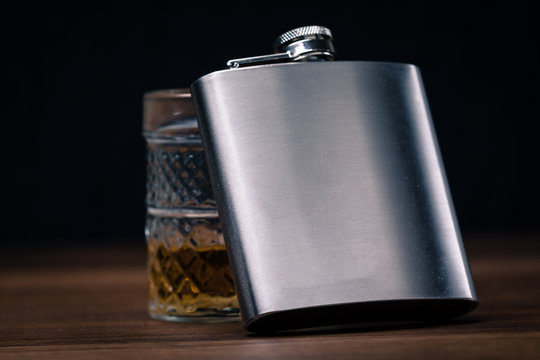 hip flask on black background
