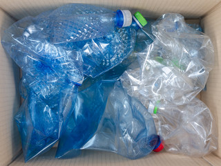 Plastic bottles discarded in the trash can  for recycling. Selective recycling concept .