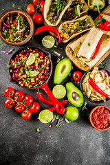 Cinco de Mayo food.Mexican food concept background with taco, quesadilla, burrito, chili, salsa sauce, hot pepper, lime. Black concrete background top view copy space