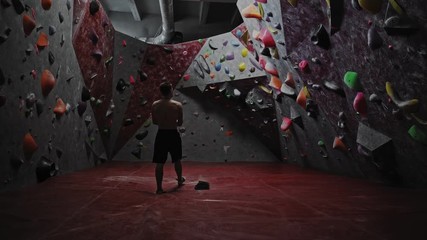 Athletic man getting ready in a bouldering gym