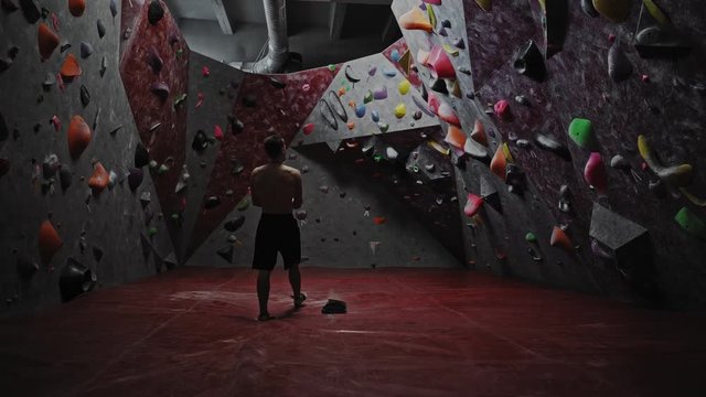 Athletic man getting ready in a bouldering gym
