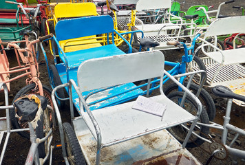 Close-up horizontal view of a group of colored old rusty bicycles with side car at an abandoned bike rental in Puerto Princesa City, Palawan, Philippines