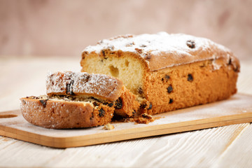 Delicious homemade cake with raisins on a light wooden background. close-up. rustic. copy space.