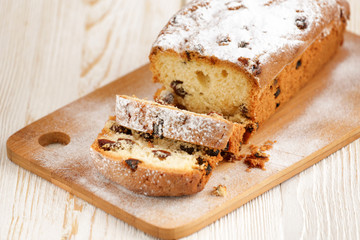 Delicious homemade cake with raisins on a light wooden background. close-up. rustic. copy space.