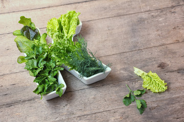 Vitamin K in food concept. Letter K shaped plate with different fresh leafy green vegetables,...