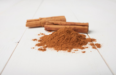 Cinnamon sticks and powder isolated on white background