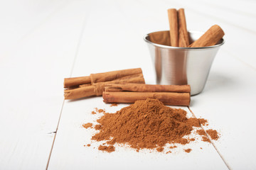 Cinnamon sticks and powder isolated on white background