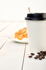 coffee with croissnt on a table wood