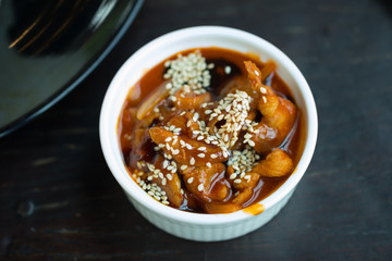 Stir fried pork with sauce and sesame in white bowl