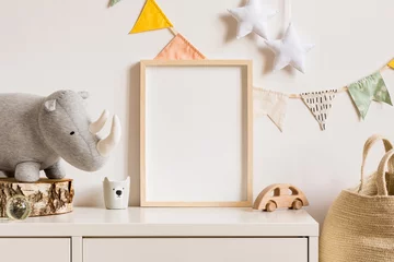 Fototapeten The modern scandinavian newborn baby room with mock up photo frame, wooden car, plush rhino and clouds. Hanging cotton flags and white stars. Minimalistic and cozy interior with white walls.Real photo © FollowTheFlow