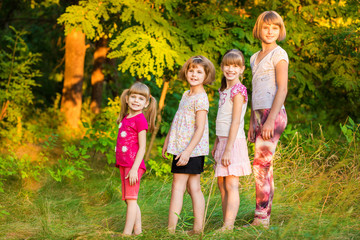 Fototapeta premium Group of happy children walk together in summer