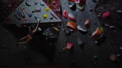 Athletic man practicing in a bouldering gym
