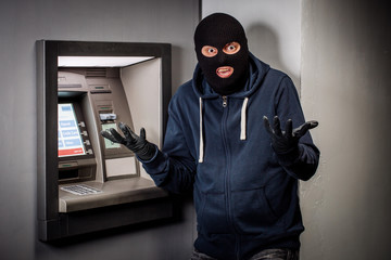 scared thief with ATM. people and emotions concept.