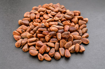 Pile of walnut on dark background.