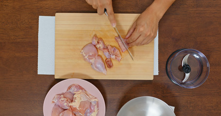 Top view of chopping chicken fillet