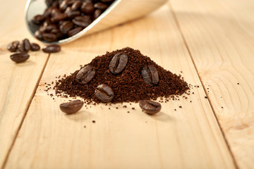 Ground coffee and coffee beans on a wooden table