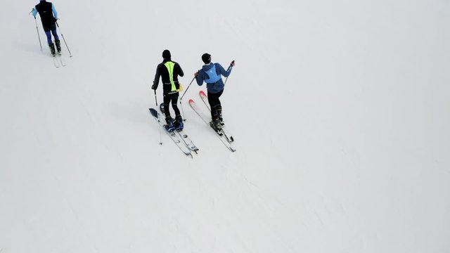 3 man skitouring at the Shymbulak mountain resort, Almaty, Kazakhstan. Aerial.