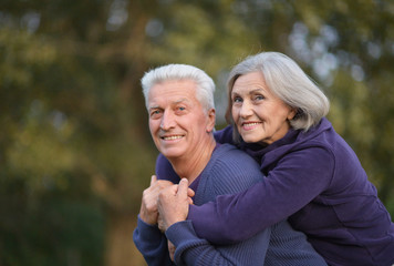 Portrait of cute senior couple in autumn park