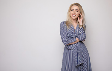 Happy smiling young businesswoman, on grey background. Caucasian blonde model in business concept...