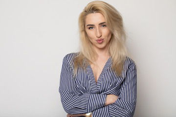 Happy smiling young businesswoman, on grey background. Caucasian blonde model in business concept...