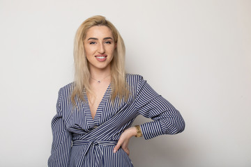 Happy smiling young businesswoman, on grey background. Caucasian blonde model in business concept...