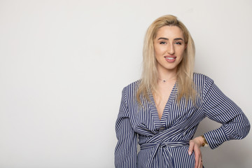 Happy smiling young businesswoman, on grey background. Caucasian blonde model in business concept...