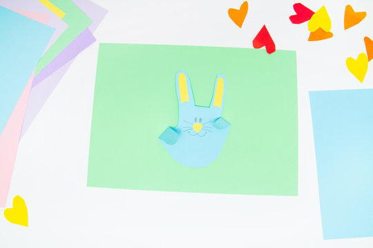 How to make paper bunny for Easter greetings and fun. Children art project. DIY concept. Kids hands makes paper craf. Step by step photo instruction. Step 12. Final. Rabbit is ready
