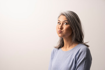 Obraz premium Beautiful mature woman is making funny faces