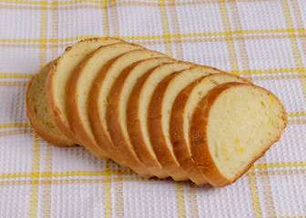 Wheat bread slices on a plate on a towel.
