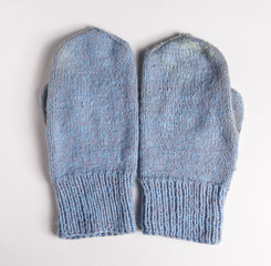 Crocheted mittens on white background