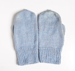 Crocheted mittens on white background