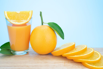 Orange juice and oranges with leaves