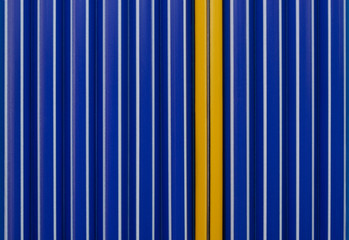 Background of one yellow pen and blue pens. Close up. Individuality concept.