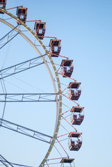 Fragment of ferris wheel in the evening lighting
