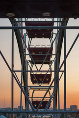 Fragment of ferris wheel in the evening lighting