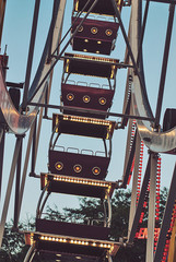 Fragment of ferris wheel in the evening lighting