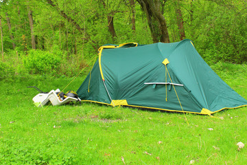 green tent river and forest