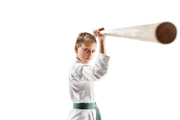 Teen boy fighting with wooden sword at Aikido training in martial arts school. Healthy lifestyle and sports concept. Fightrer in white kimono on white background. Karate man in uniform.