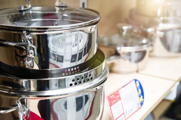 A set of stainless steel utensils on the shelves of the store, close-up