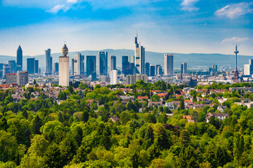 The famous skyline of Frankfurt, Germany on a beautiful sunny day with a blue sky. The panoramic view northwards to Frankfurt's skyscrapers shows all the impressive buildings like the Henninger Tower. - obrazy, fototapety, plakaty