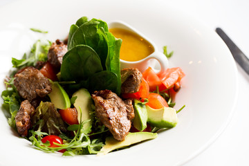 warm goyavidina salad with avocado and sauce