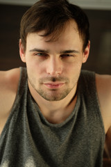 Fototapeta premium Portrait of a handsome man doing exercises at home