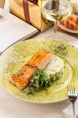 Grilled Salmon with fresh salad and mashed potatoes on wooden table