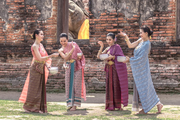 Thailand culture. Thai girls and thai women playing splashing water during with Thai Traditional costume in the temple of Ayutthaya Thailand festival Songkran festival.