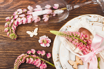 Tableware with pink lupines and silverware