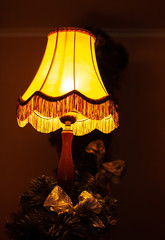 interior of the restaurant is dimmed light in the hall. on the table is a retro table lamp shines yellow