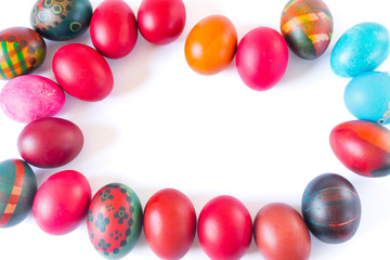 Colorful easter eggs making a frame isolated on white background.